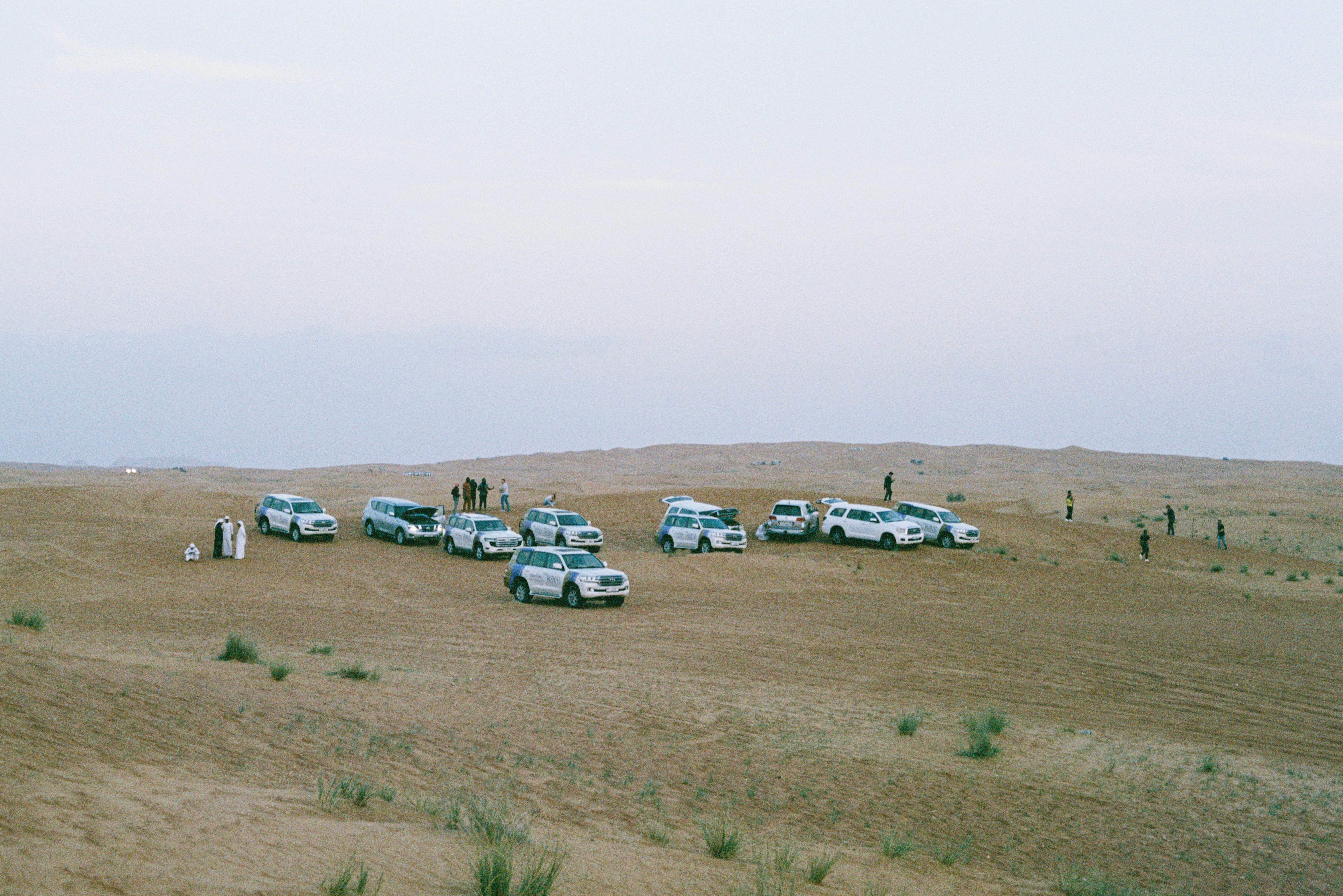Dubai desert safari vehicles and guests preparing for the experience